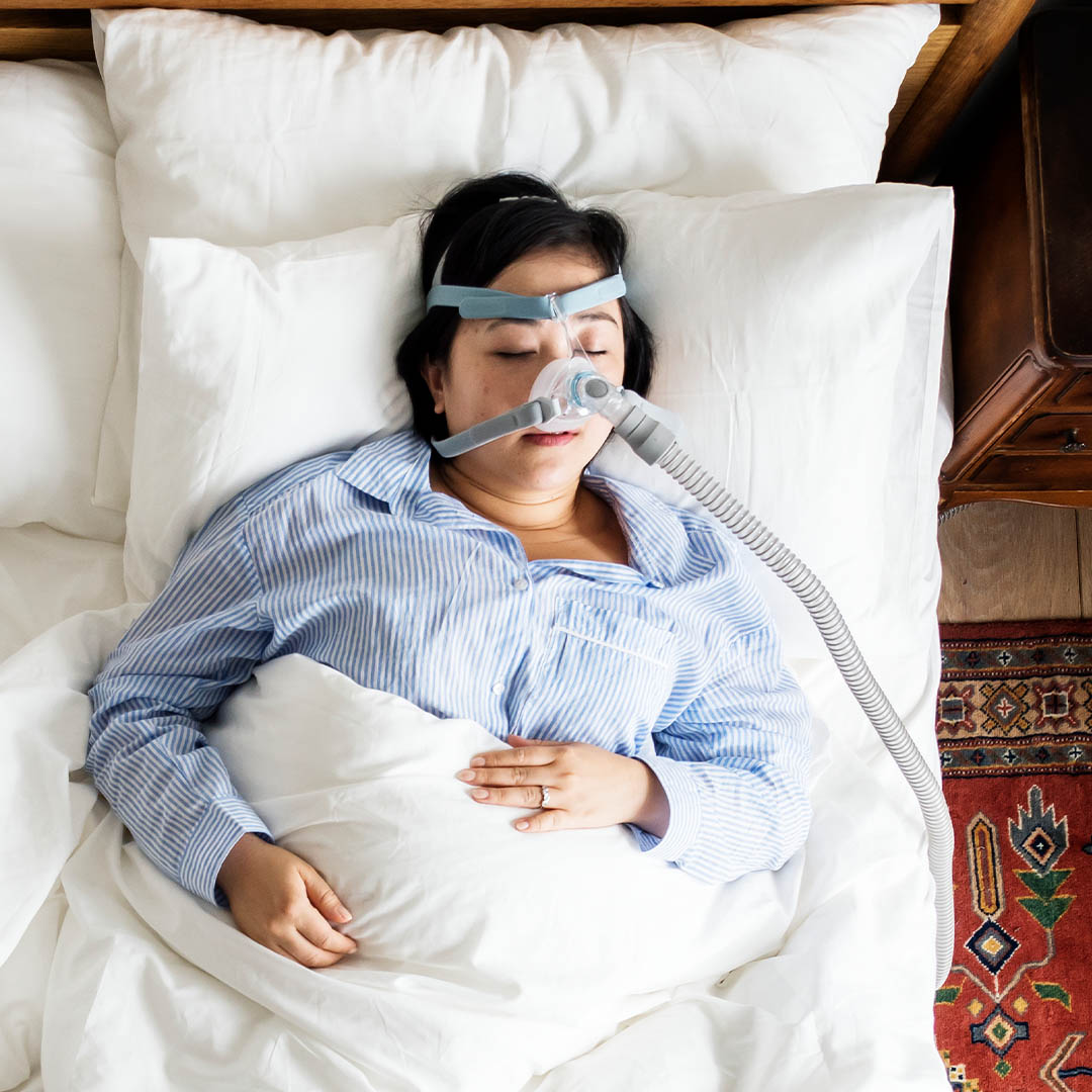 Woman sleeping with CPAP machine