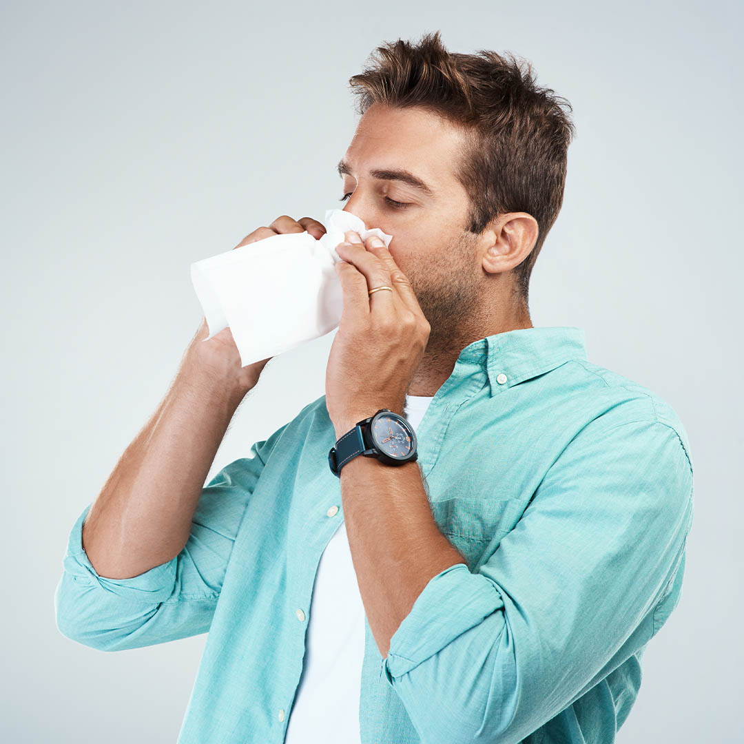 Man blowing his nose.